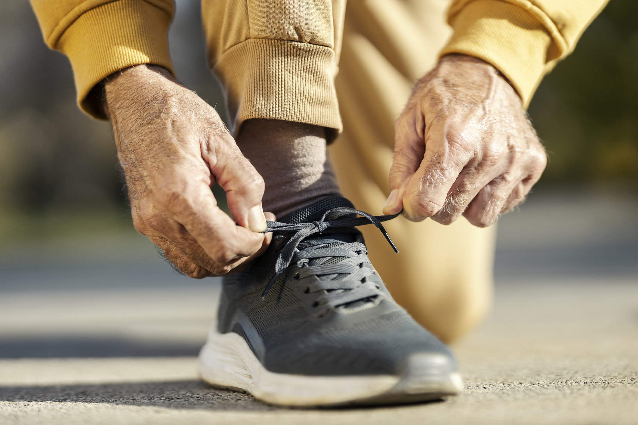 Person in exercise clothes tying their tennis shoe